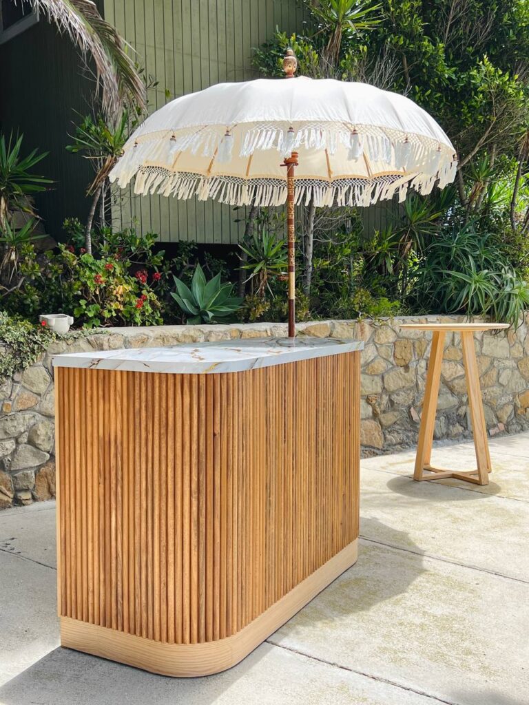 Cocktail setup — Oak Bar Table, BACARDI Bar, Balinese Bali Umbrella – 6ft | Vogue Rentals